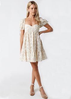 Throw on the Jessie Cream and Pink Floral Babydoll Mini Dress and meet your friends for brunch! Woven cream and pink floral fabric shapes a sweetheart neckline, empire bodice, and puffy short sleeves with ties and elasticized shoulders. The babydoll silhouette continues to a flirty mini skirt with a ruffle hem. DETAILS & FIT S: 29" Length, 24" Bust, 44" Hips M: 30" Length, 26" Bust, 46" Hips L: 30.5" Length, 29" Bust, 48" Hips Short Babydoll Bodice. 100% Cotton. Machine wash cold. Imported. SHIP Cream Babydoll Dress, Pink Babydoll Dress, Cute Mini Dresses, Pink Floral Fabric, Stylish Fits, Pink Babydoll, Church Fits, Babydoll Mini Dress, Dress With Puff Sleeves