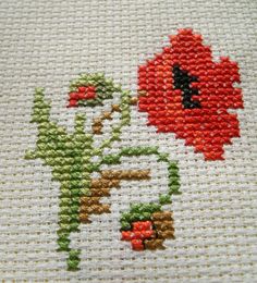 the cross stitch pattern shows an image of a red flower