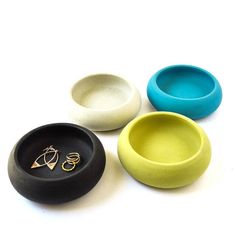 three different colored bowls with rings on them