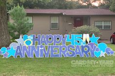 a yard sign in front of a house that says happy anniversary with stars and hearts