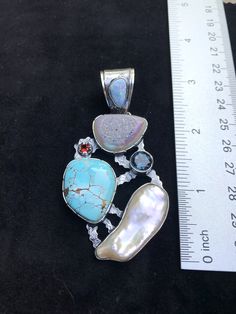 "Artisan Turquoise gemstone Pendant Hand-made Sterling Silver 925. Stones used: Rainbow Druzy, Turquoise, Australian Opal, Pearl, London Blue Topaz, Garnet Height - 3\" (with bail), Width - 1 5/8\" Height -75mm (with bail), Width - 40mm Unique Handcrafted One-of a-kind Design Each Piece of Jewelry in my Collection is Absolutely One of a Kind! When you start wearing a piece of my jewelry you will fall in love with it more and more each day and feel that good Energy and Love that I pass into it wh Elegant Turquoise Necklace For Gift, Turquoise Gemstone Fusion Jewelry, Fusion Turquoise Gemstone Jewelry, Fusion Style Turquoise Gemstone Jewelry, Blue Multi-stone Fusion Gemstones, Artisan Turquoise Jewelry For Anniversary, Turquoise Sterling Silver Pendant Gemstone, Turquoise Natural Stones Pendant Gemstones, Turquoise Pendant Gemstone