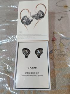 two earphones in packaging on a table