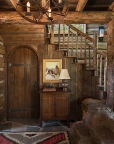 a room with wooden walls and stairs