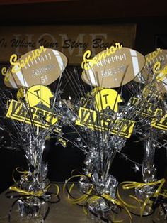 a group of vases that are sitting on a table with yellow ribbon around them