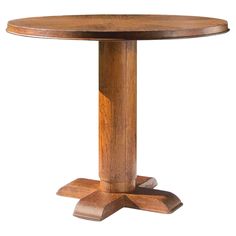 a round wooden table with two pedestals