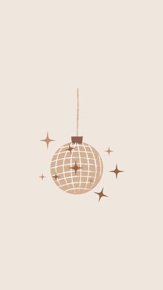 an ornament hanging from a string with stars around it on a beige background