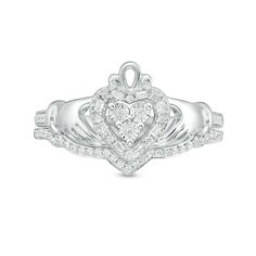 Shimmering with heritage, this diamond Claddagh bridal set is a timeless choice. Crafted in sterling silver, the engagement ring showcases a sparkling diamond-touched heart, hands and crown design with additional diamonds along the shank. On your wedding day, a coordinating diamond-lined chevron wedding band completes the look. Radiant with 1/5 ct. t.w. of diamonds and a bright polished shine, this bridal set expresses your love. Custom-made to fit her ring size. Sterling silver rings cannot be resized after purchase. Claddagh Engagement Ring, Chevron Wedding Band, Zales Engagement Rings, Claddagh Ring Wedding, Chevron Wedding, Her Ring, Claddagh Rings, Bridal Engagement Rings, Crown Design