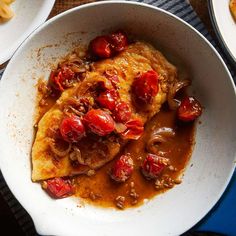 a white bowl filled with food on top of a table