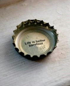 a bottle cap with the words life is better barefoot on it