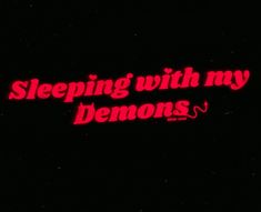 the words sleeping with my demons are lit up in red on a black background,