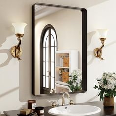 a bathroom sink sitting under a mirror next to a vase with flowers on top of it