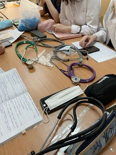 a group of people sitting around a table with medical equipment on it's desk