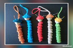 three crocheted items are hanging from strings