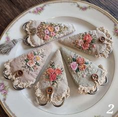 four pieces of fabric with flowers are on a plate