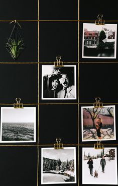 black and white photos hanging on a wall with gold pins attached to them, along with other pictures