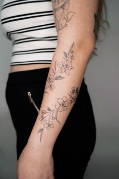 a woman with a flower tattoo on her arm