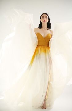 a woman in a yellow and white dress