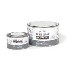 an open can of annie sloan chalk paint next to a tin of the same color