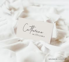 a name tag that reads cafferine williams on top of a white bed sheet