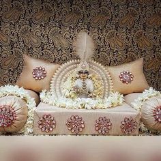 an elaborately decorated couch with decorative pillows