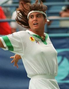 a female tennis player in action on the court