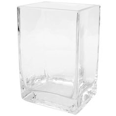 a clear square vase sitting on top of a white surface with no one in it