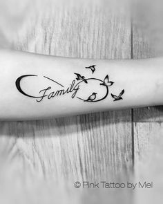 a tattoo with birds flying around it and the word family written in cursive writing