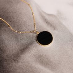 Black Obsidian Circle Pendant Necklace for Her - Minimalist geometric jewelry on 14k gold filled satellite chain Size: 20mm diameter Note that due to the handmade nature of these genuine stones, measurements are approximately and might vary slightly for each stone. Chain: Satellite Chain 18, 20, 24 inches(choose from menu) Chain Material: 14k Gold Filled with spring ring clasp. Bail of the pendant is Vermeil Gold (14k gold plated over Sterling Silver) Arrives in giftbox. Made in the USA. Model i Necklace For Her, Circle Pendant Necklace, Gold Circle, Geometric Jewelry, Black Obsidian, Circle Pendant, Chains Jewelry, Spring Rings, Jewelry Care