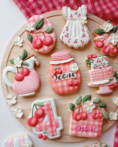 decorated cookies are arranged on a wooden plate