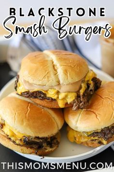 three cheeseburger sandwiches on a plate with the words black stone smash burgers