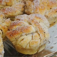 several pastries on a metal tray covered in powdered sugar