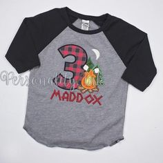 a child's shirt with the number three on it, and a campfire