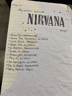 a notepad with writing on it that has been written in the language nirvana and is attached to a clipboard