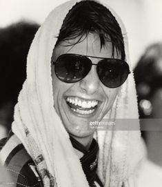 elvis presley wearing sunglasses and a scarf smiles for the camera in this black and white photo