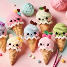 crocheted ice cream cones with cute faces on them and balls of yarn in the background