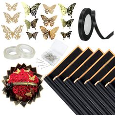 the contents of a butterfly decoration kit including black and gold butterflies, ring holders, earring clips, and more