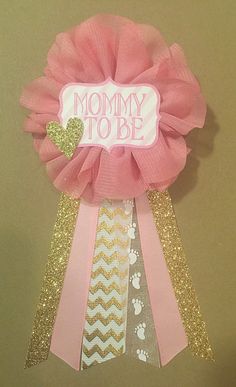 a card that says mommy to be with ribbons and bows on it's side