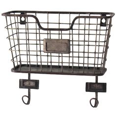 a metal basket hanging from the side of a wall with hooks on it and an iron hook