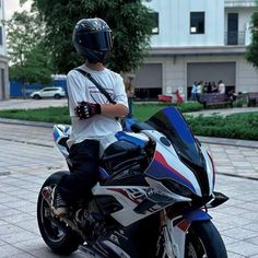 a young man sitting on top of a motorcycle