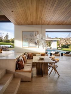 a living room filled with furniture next to a swimming pool