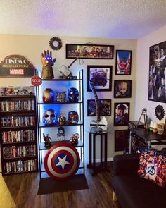 a living room with captain america memorabilia on the wall and pictures on the walls above it