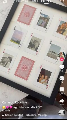 a person holding up a framed photo with playing cards on it