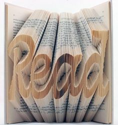 an open book with the word eco written on it and folded pages in the shape of letters