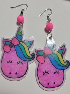 These unicorn shrinky dink earrings are bright and colorful. The pair pictured is the ones you will receive in your order. The hang 3-1/4 inches and are resin coated to protect the color. The ear wires are easily adjustable :) Shrinky Dink Earrings, Shrink Plastic Jewelry, Mallow Flower, Colorful Unicorn, Earrings Kawaii, Unicorn Earrings, Shrinky Dink, Kawaii Earrings, Velvet Heart