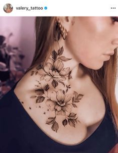 a woman's neck tattoo with flowers on it