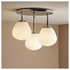 three lights hanging from the ceiling in a room