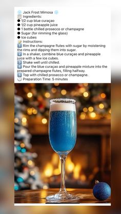 a blue drink sitting on top of a table next to a christmas tree