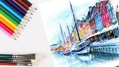 colored pencils are next to a drawing of boats