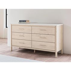 a white dresser sitting on top of a hard wood floor