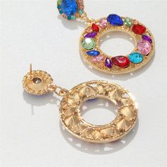 Eye-catching round drop earrings featuring multi-color crystal and cubic zirconia set in an 18k gold-plated finish. 1.26" W x 2" L 18k gold-plated copper / crystal / cubic zirconia Copper Crystal, Color Crystal, Blue Crystals, Washer Necklace, Red Blue, Red And Blue, Crochet Earrings, Cubic Zirconia, Statement Necklace